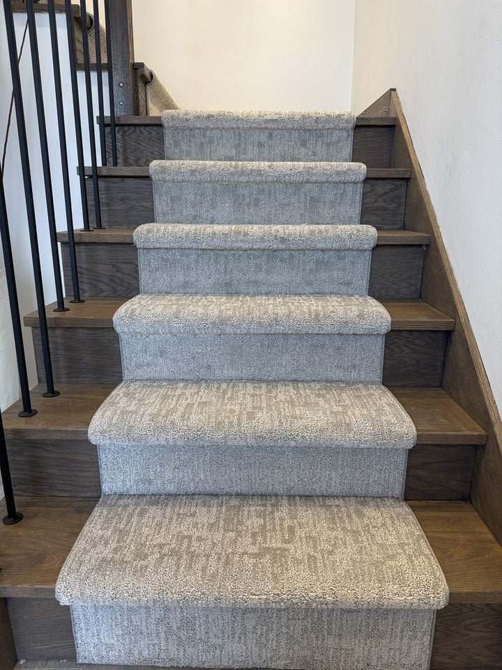 Mallard Manor Mist Gray stair runner carpet on dark hardwood stairs with white walls