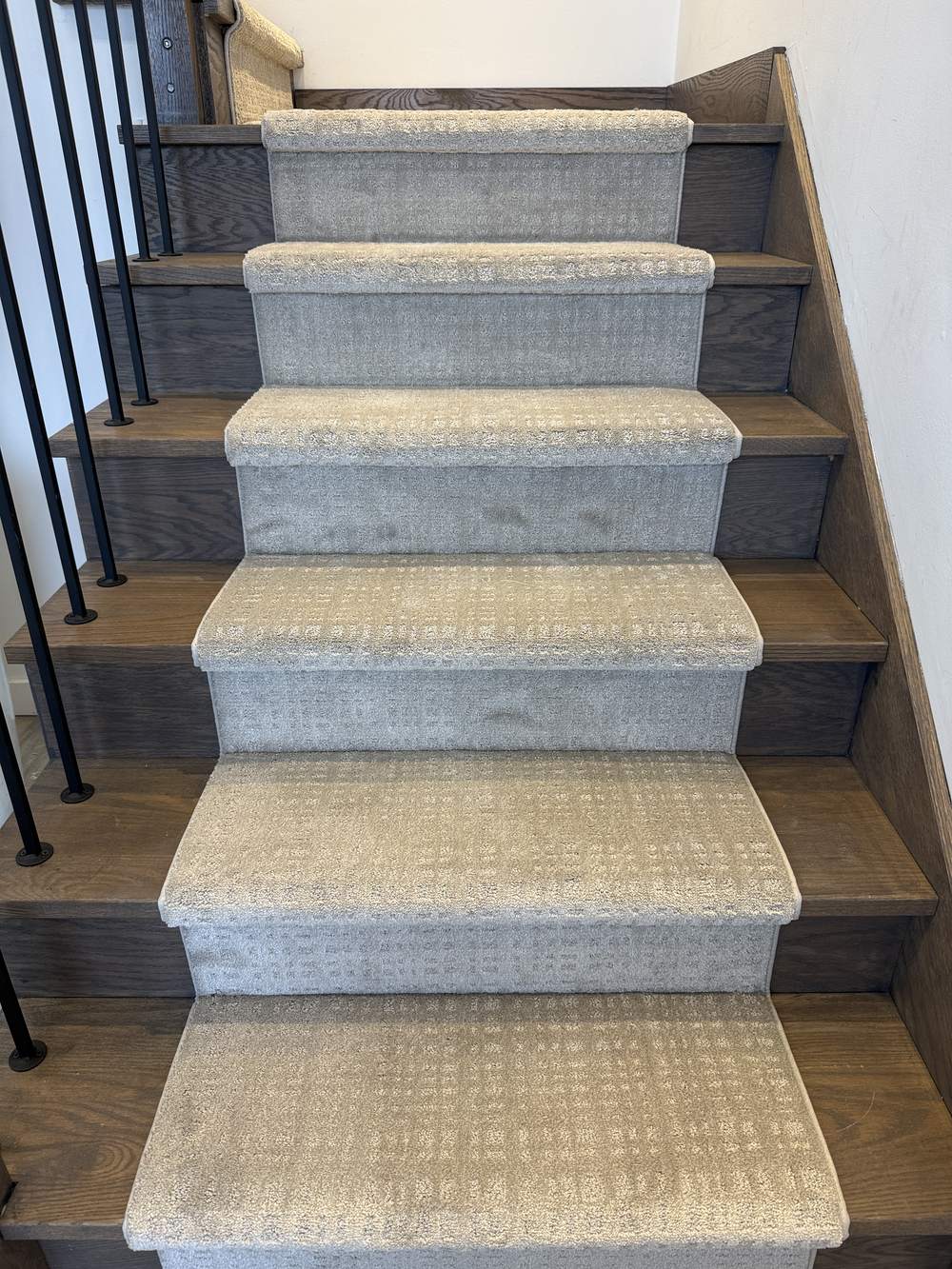 Tanager Lodge Brown Bag stair runner carpet on dark hardwood stairs with white walls