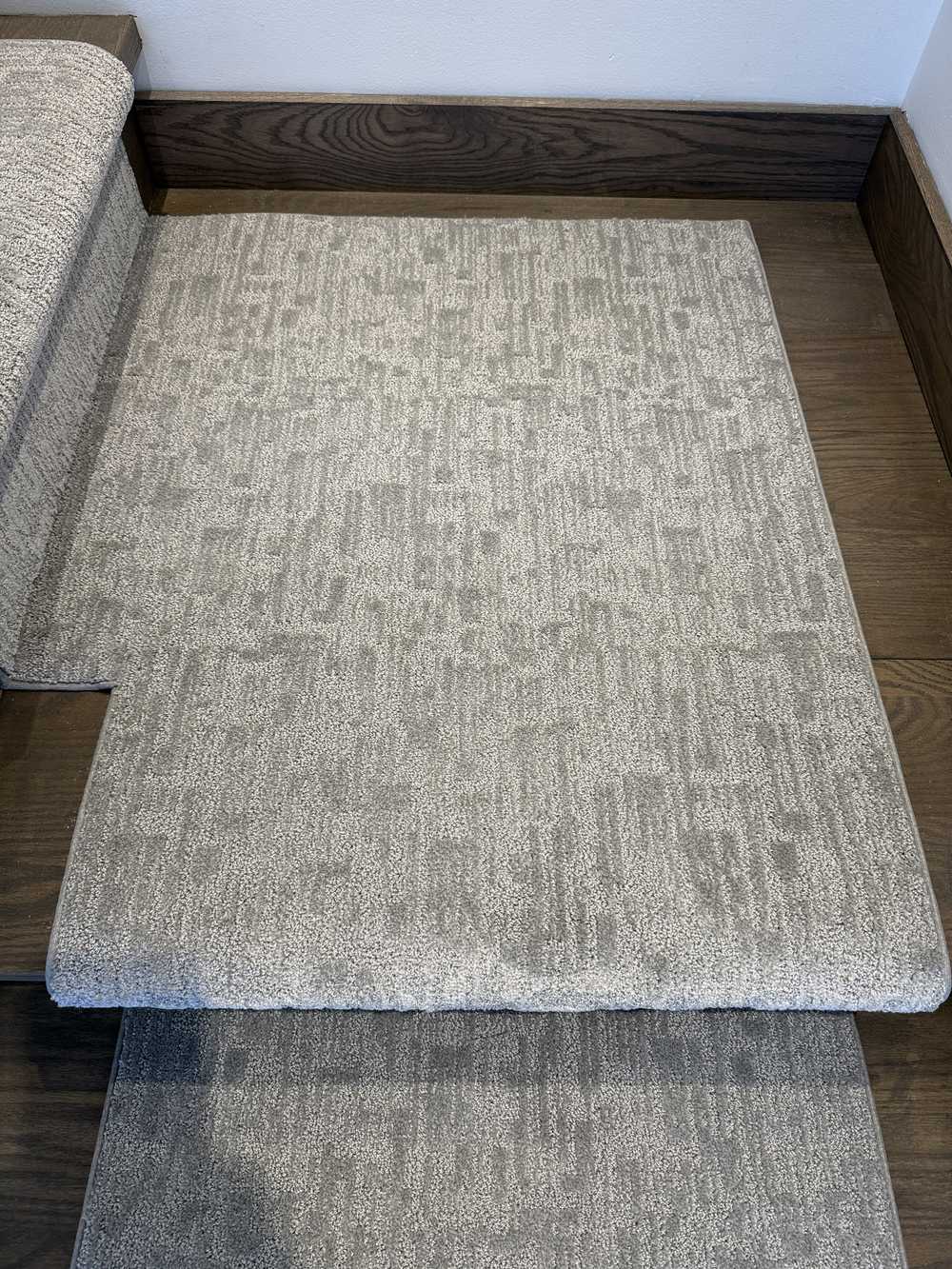 90 degree left turn landing carpet for Mallard Manor Mist Gray stair runner on dark hardwood stairs