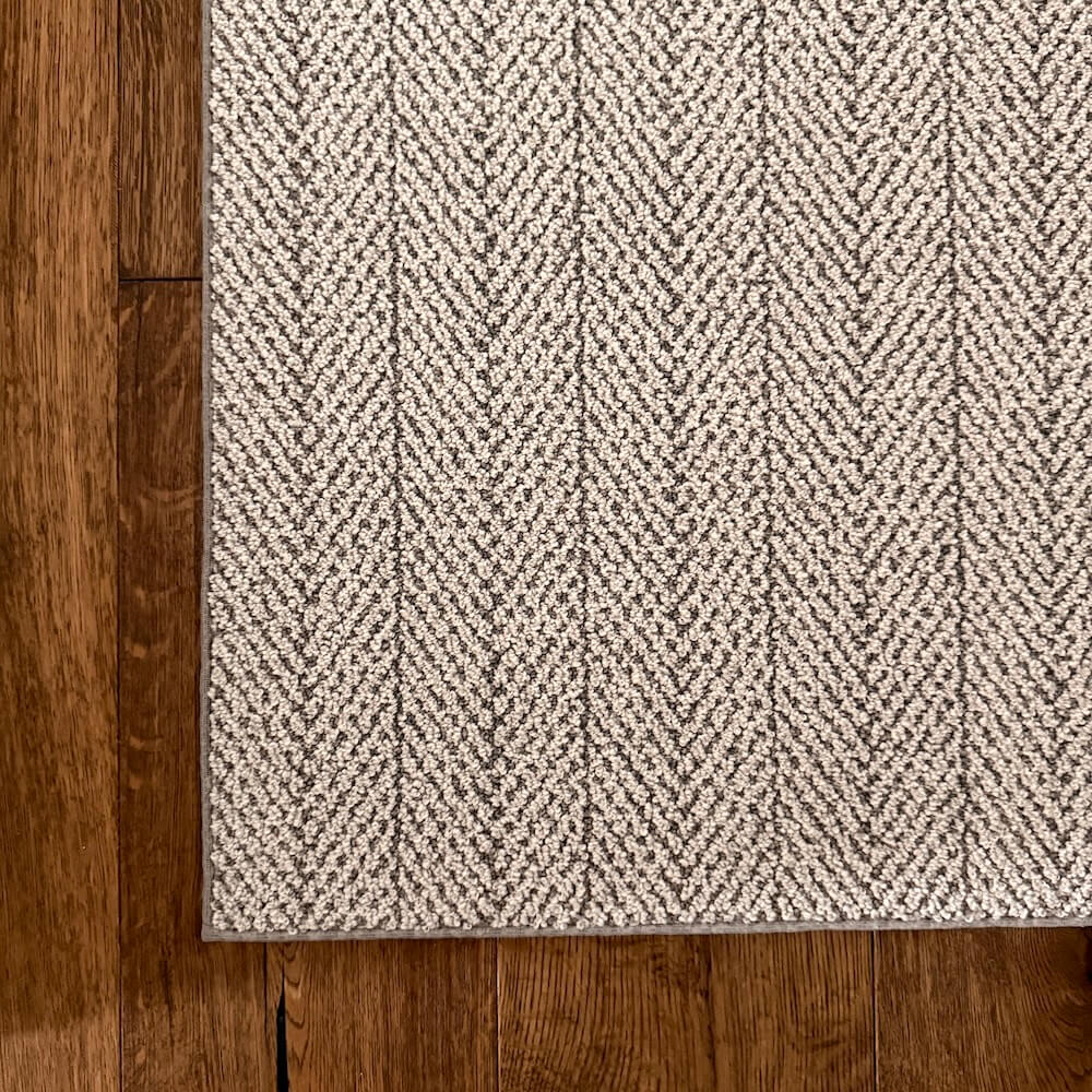 Grey hallway runner on wood planks