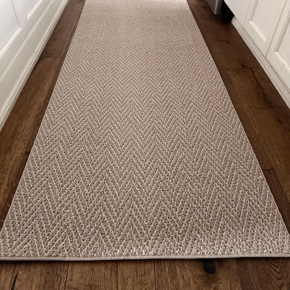 Beige textured runner rug on a wooden floor