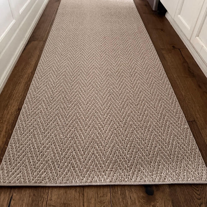 Beige textured runner rug on a wooden floor