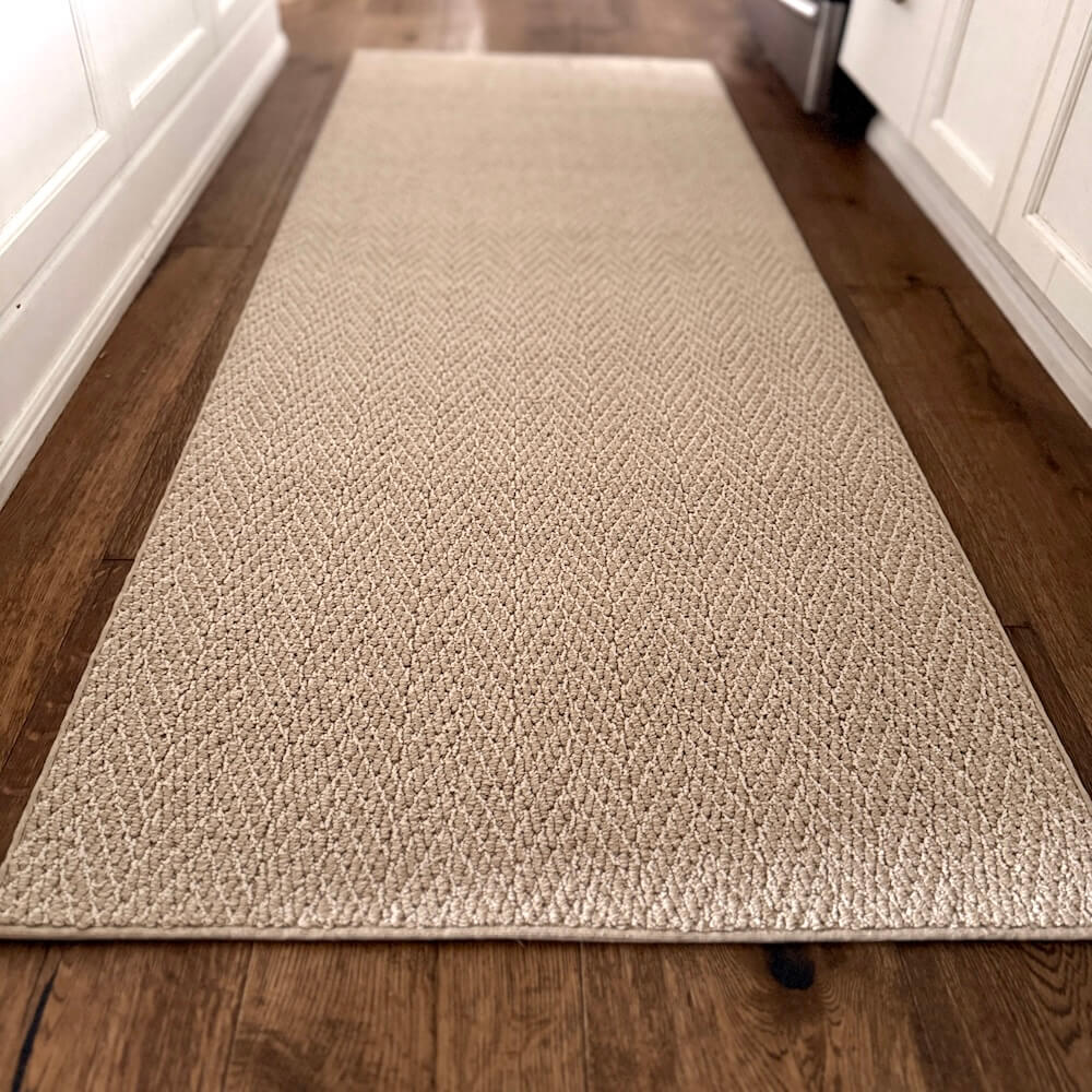 Beige textured runner rug on a wooden floor