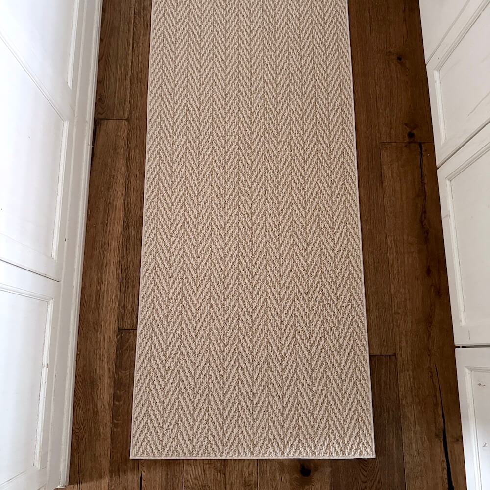 Beige patterned rug on a wooden floor