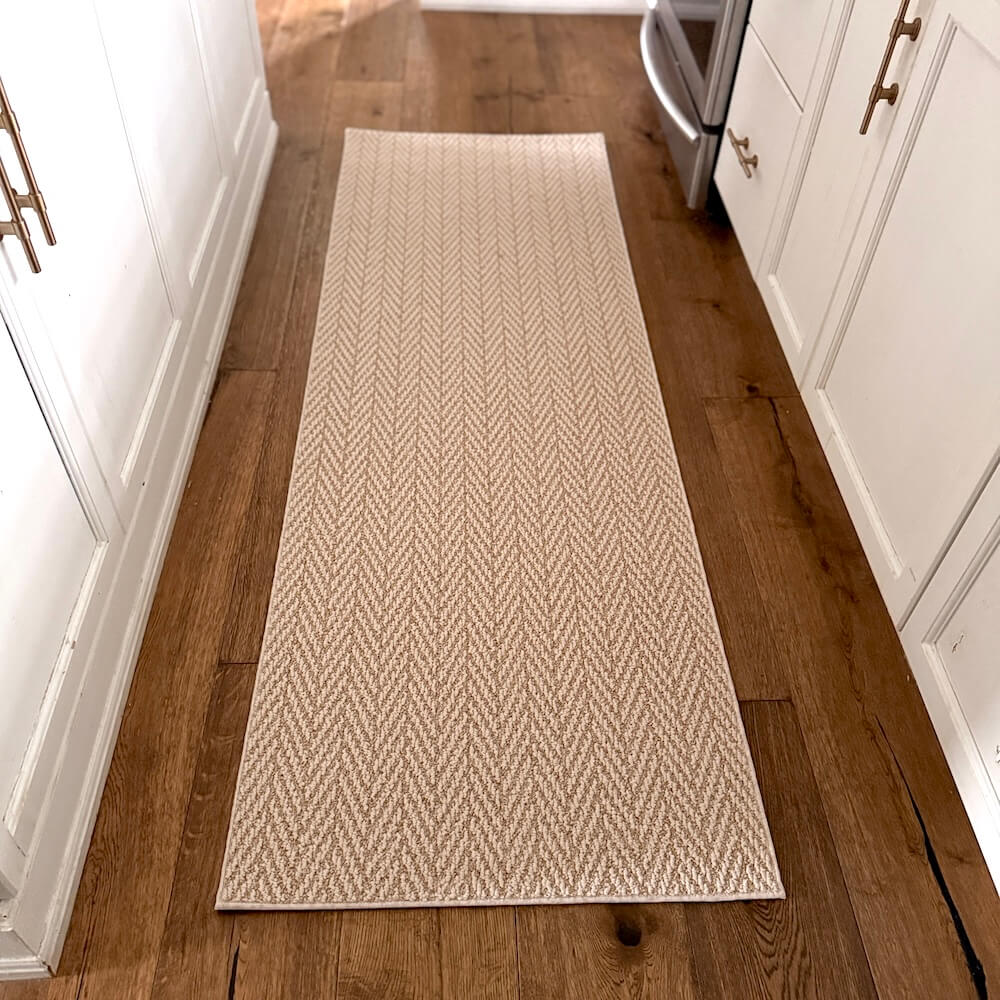 Beige woven runner rug on a wooden floor in a kitchen setting