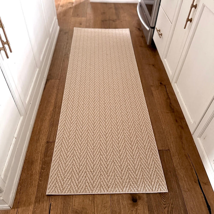 Beige woven runner rug on a wooden floor in a kitchen setting