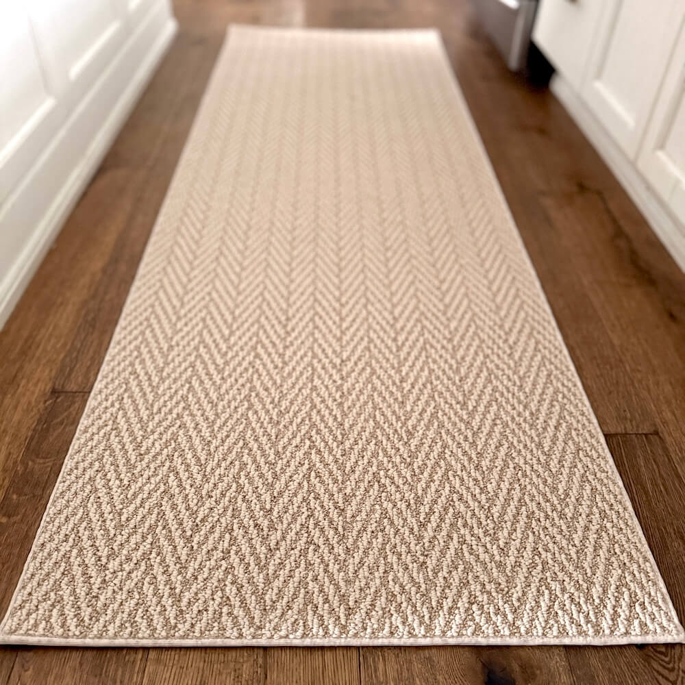 Beige woven runner rug on a wooden floor