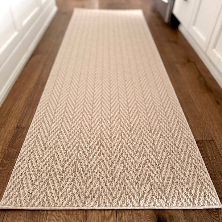 Beige woven runner rug on a wooden floor