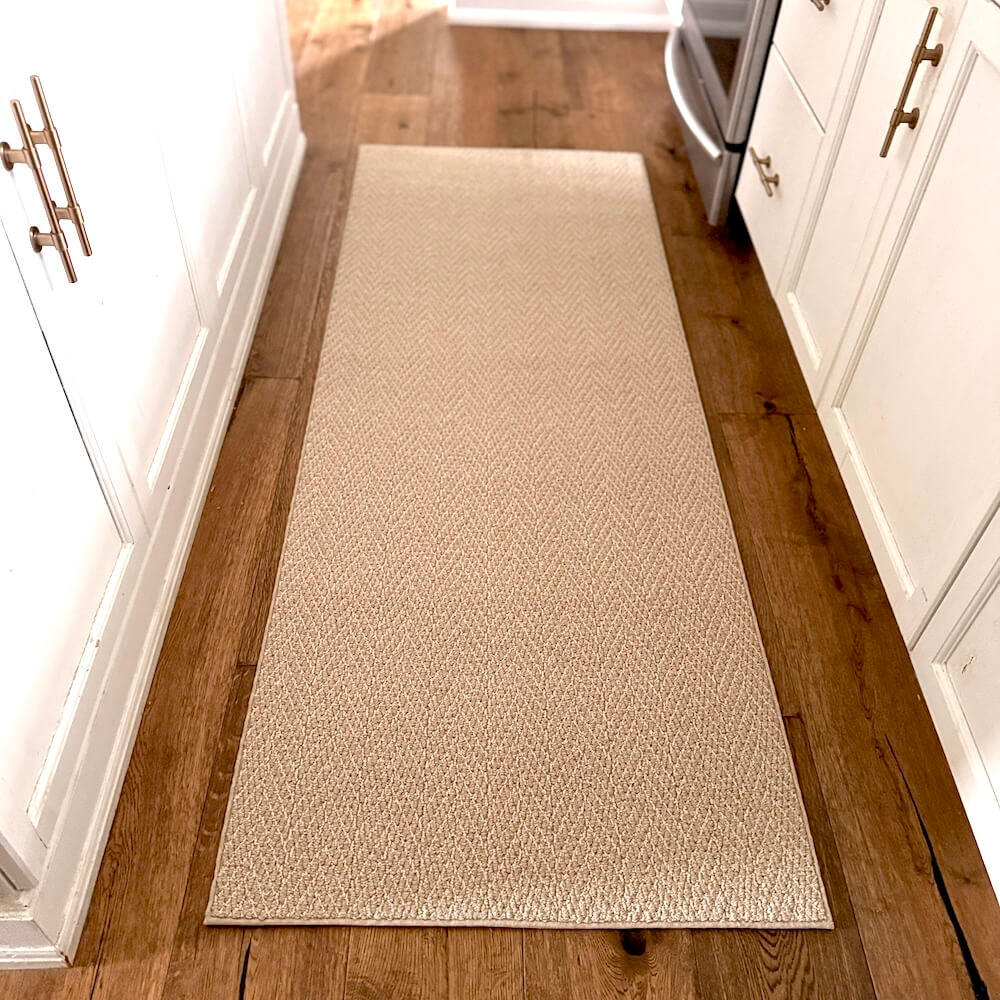 Beige runner rug on a wooden floor in a kitchen setting