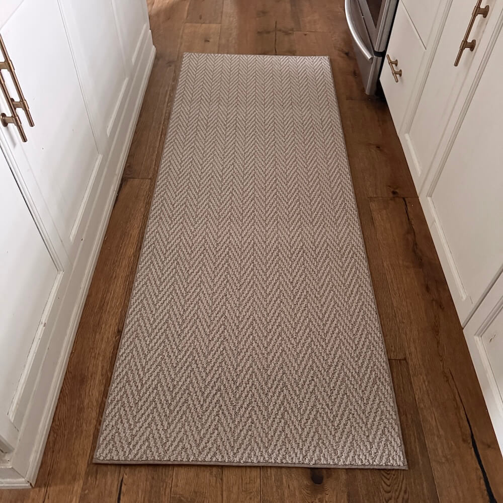 Patterned rug on a wooden floor in a kitchen setting