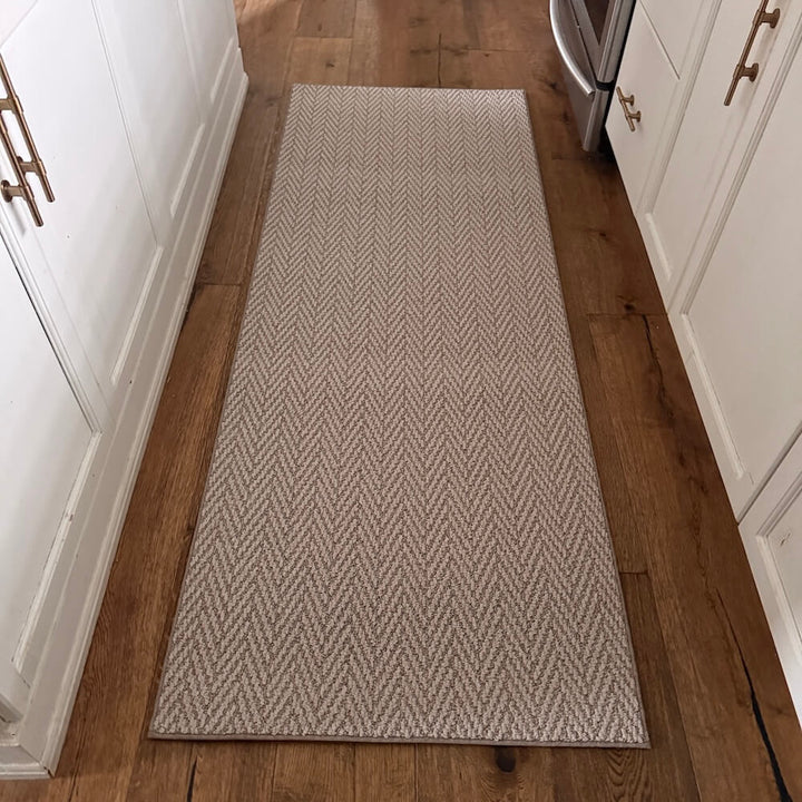 Patterned rug on a wooden floor in a kitchen setting