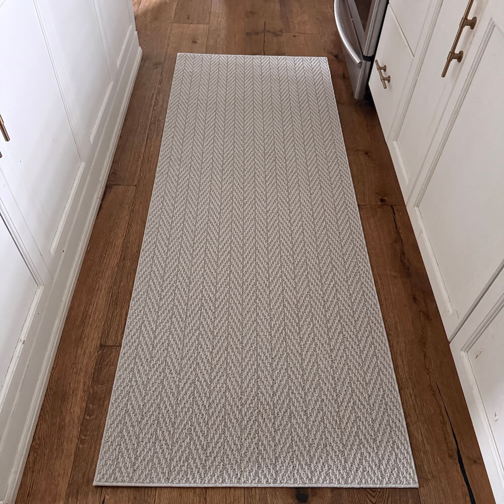 Patterned rug on a wooden floor in a kitchen setting