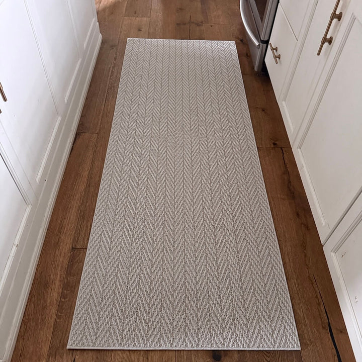 Patterned rug on a wooden floor in a kitchen setting
