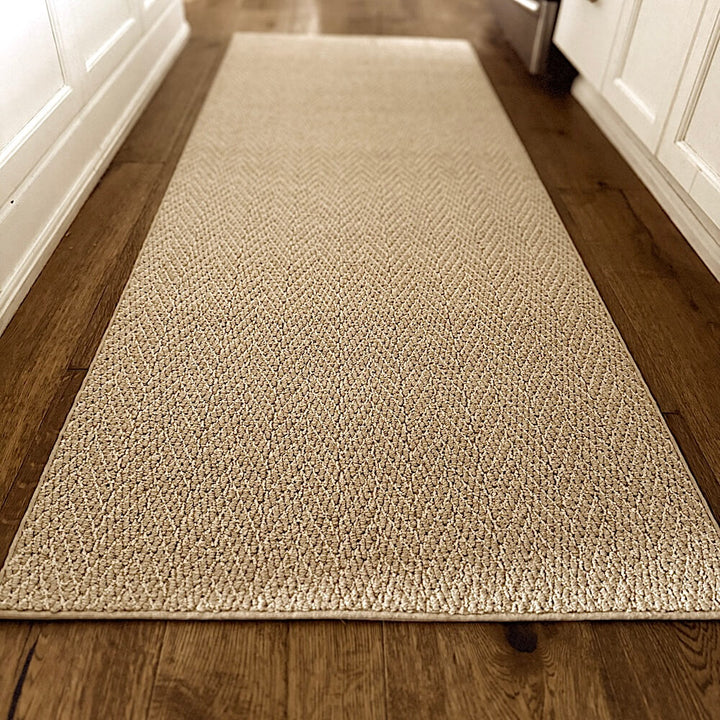 Beige textured rug on a wooden floor