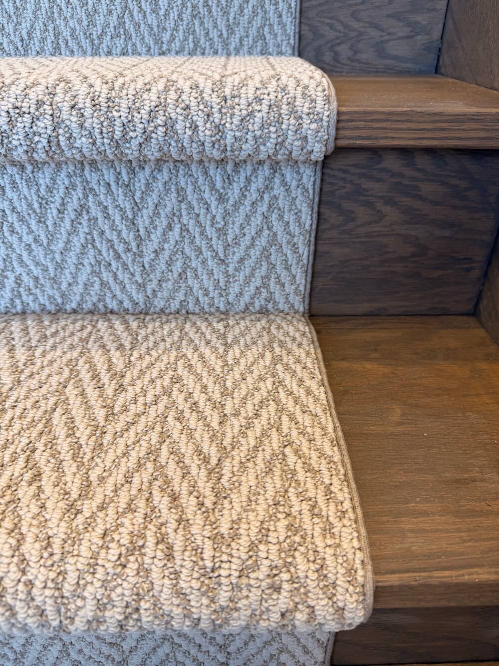 Textured blue and beige stair runner on wooden stairs