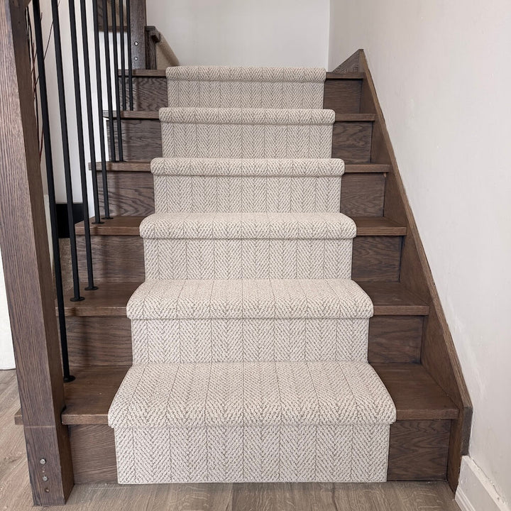 Wooden staircase with patterned carpet runner in a home setting