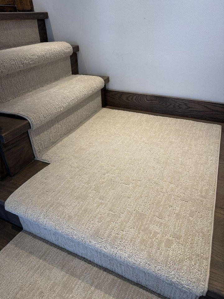 Stair runner with matching landing carpet on dark hardwood stairs