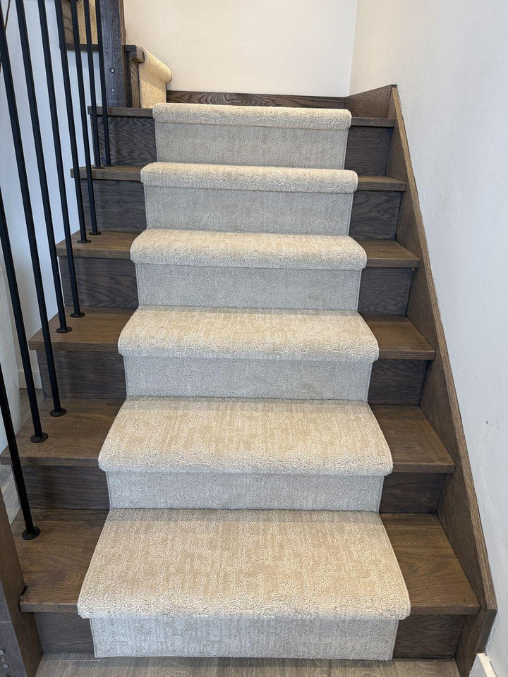 Modern pattern stair runner carpet on dark hardwood stairs