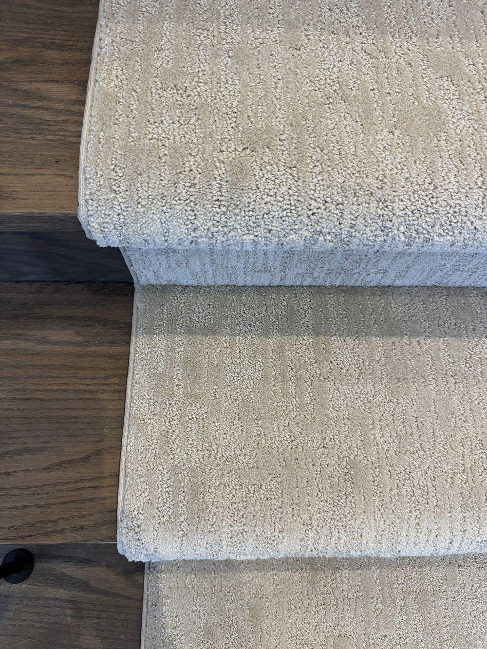 Close-up of Mallard Manor stair runner carpet on dark stained stairs