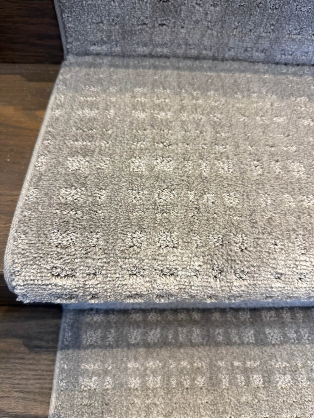 Top view gray stair runner on dark wood stairs