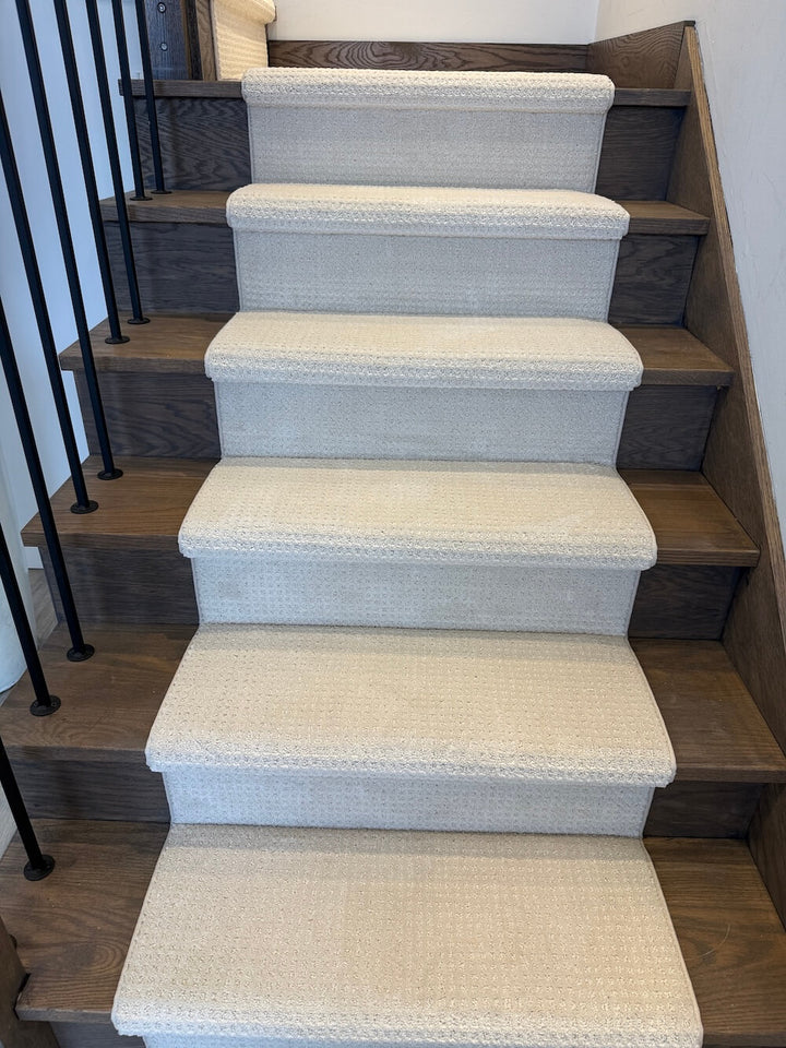 beige patterned stair runner on walnut color hardwood stairs