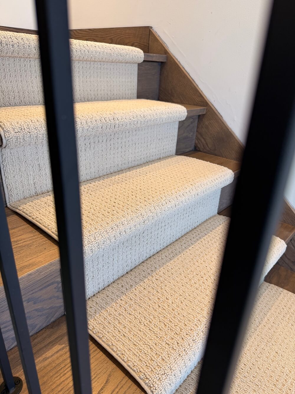 side view of stair runner carpet on wood stairs