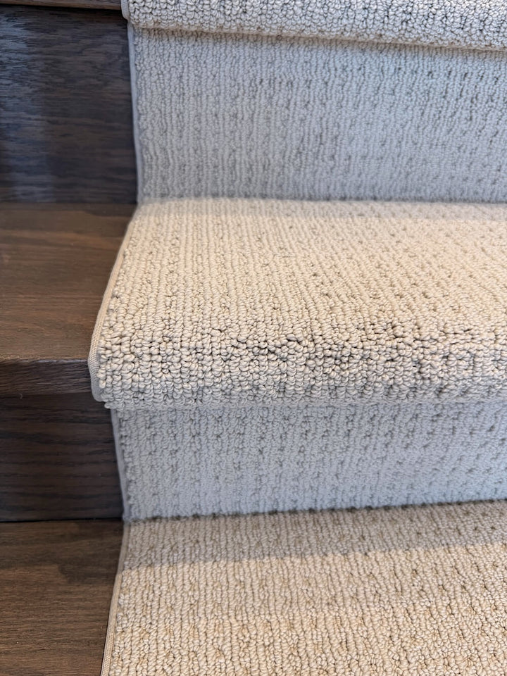 Close-up of carpeted stairs with a textured pattern