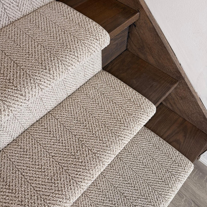 Textured beige carpet on wooden stairs