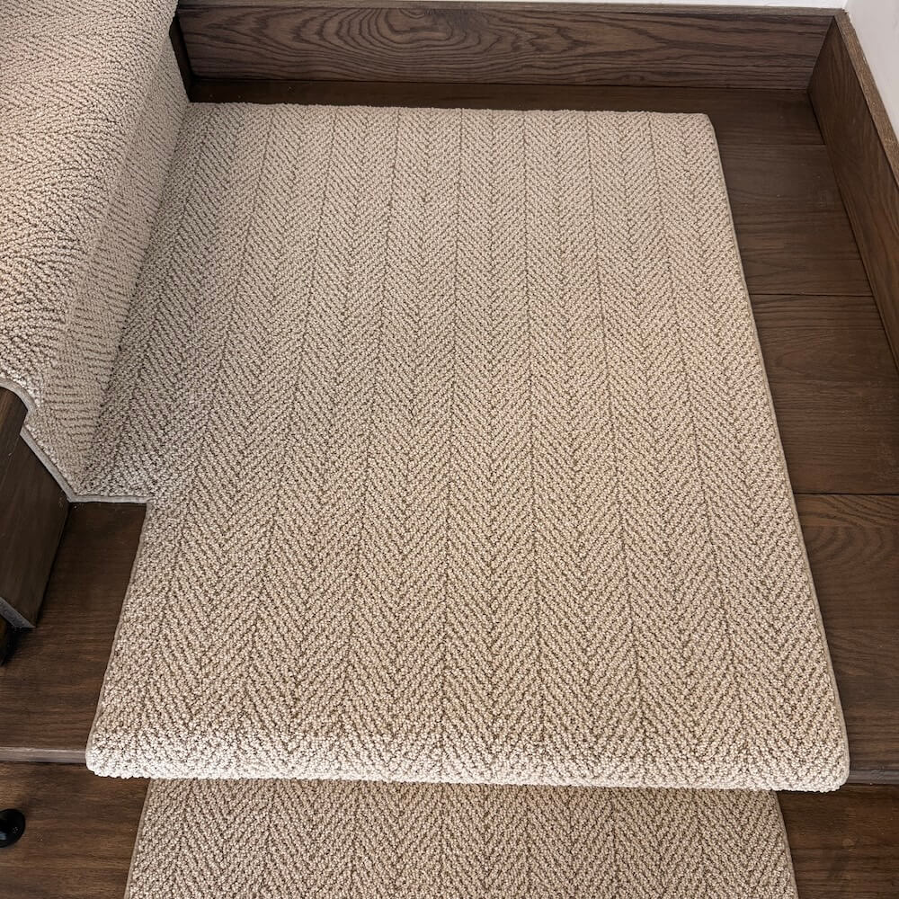 Beige textured stair runner on wooden stairs