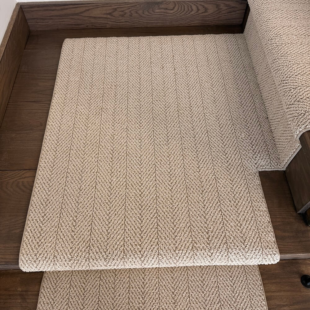 Beige berber stair runner on a wooden stairs