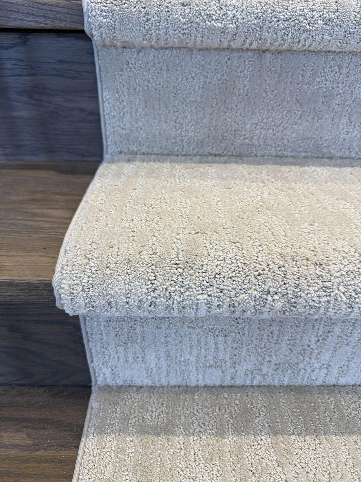 Top view of beige gray stair runner on wood stairs